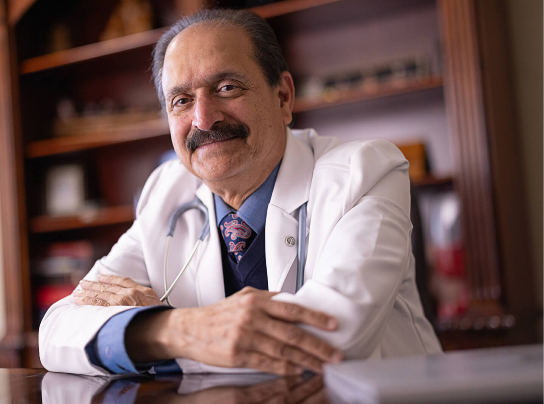 Physician wearing white lab coat and smiling